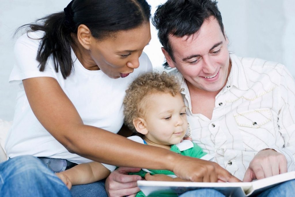 parents reading to toddler